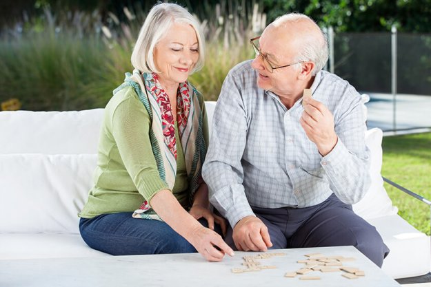 Happy Senior Couple Playing Dominoes At Porch Happy Senior Couple Playing Dominoes At Porch