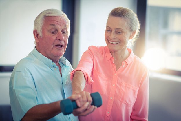 Senior couple exercising at home Senior couple exercising at home