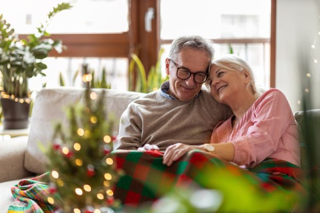 Senior couple sitting in the living room together during Christm 5 Reasons To Move To Elderly Assisted Living In Dallas, TX During Winter