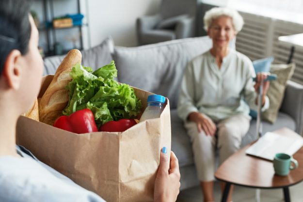 Caregiver Delivering Groceries to Senior Woman Exploring Assisted Living In Bluff View, TX: 7 Mistakes You Should Avoid