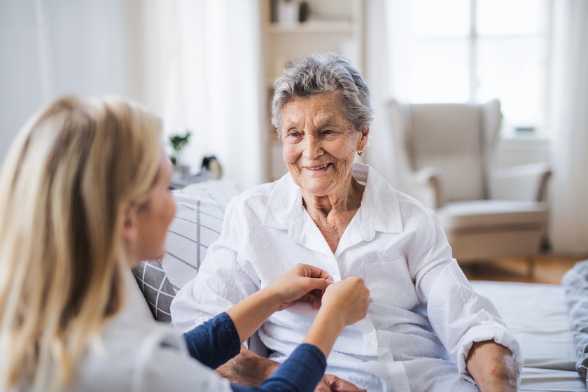 A health visitor helping a sick senior woman sitting on bed at home. How Long Do You Need To Stay In Highland Meadows, TX Assisted Living?