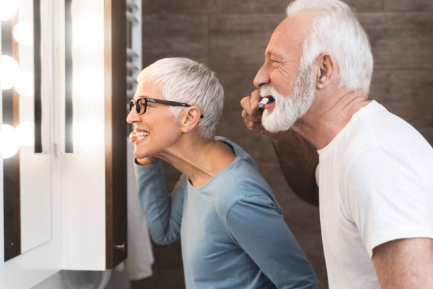 Senior couple together in the bathroom Living In Senior Retirement Homes In Vickery Meadow, TX: Nighttime Habits For Better Sleep Quality