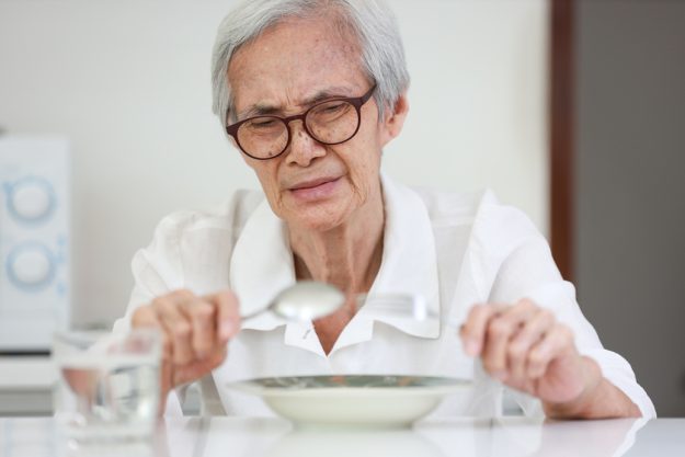 Disappointed old people looking at food on dish,eating leftovers 6 Supposedly Healthy Food Seniors Should Avoid