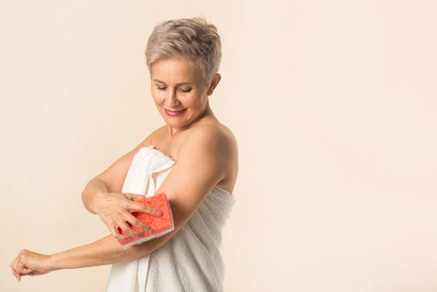 Stylish beautiful aged woman in a white towel Stylish beautiful aged woman in a white towel