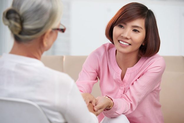 Woman talking to senior mother Woman talking to senior mother