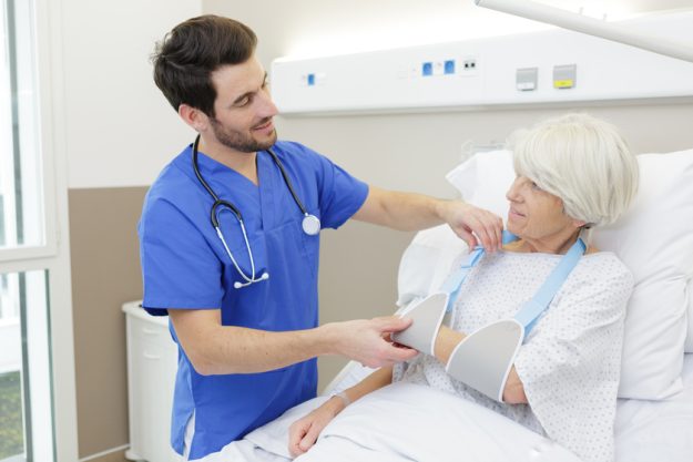 male doctor taking care senior woman Ensuring Continuity: Transitioning Back To A Memory Care Center In Old Preston Hollow, TX After Hospitalization