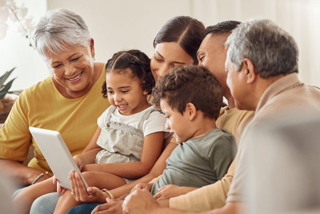 Family, home and people with tablet streaming a movie Family, home and people with tablet streaming a movie