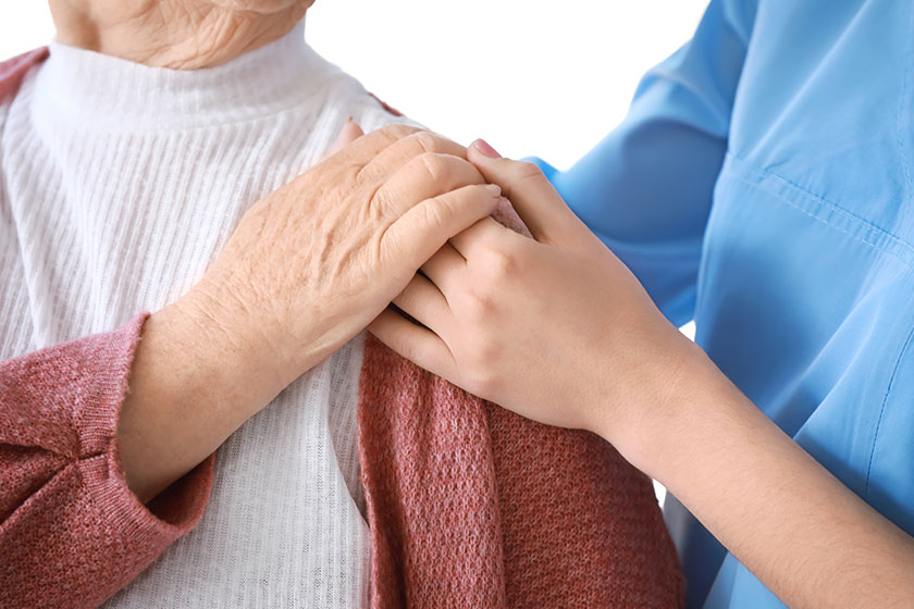 Medical worker with senior woman in nursing home