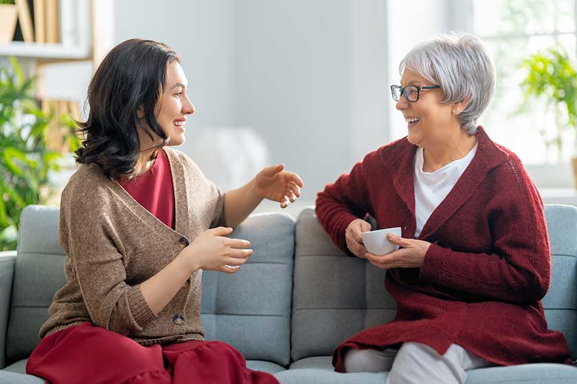 Beautiful-mother-and-daughter-are-talking-and-smiling-while Beautiful-mother-and-daughter-are-talking-and-smiling-while