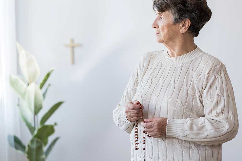 Religious-grandmother-praying-in-church Religious-grandmother-praying-in-church