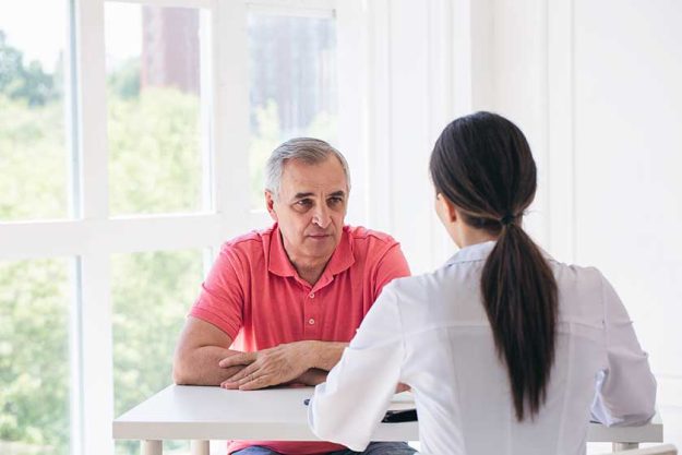 Senior-patient-listen-to-young-woman-doctor-in-a-hospita