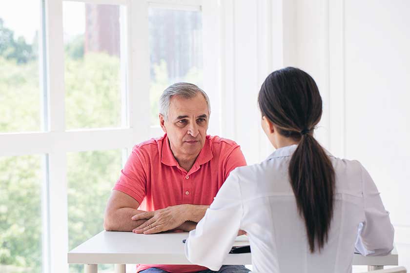 Senior-patient-listen-to-young-woman-doctor-in-a-hospita Senior-patient-listen-to-young-woman-doctor-in-a-hospita