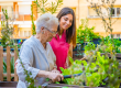 nurse-elder-woman-cultivating-plants-garden-geriatric