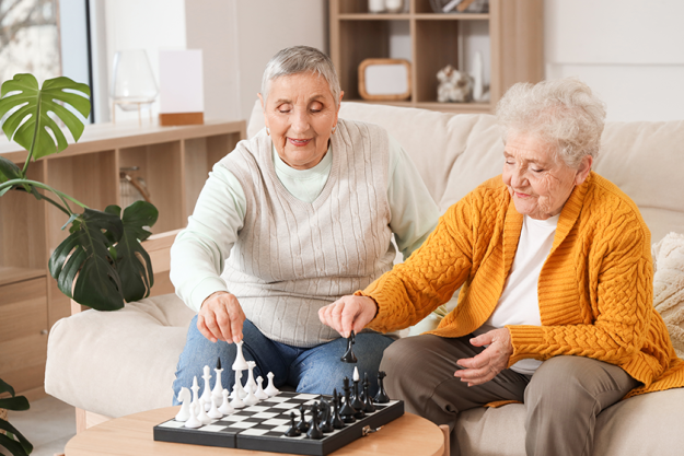 senior-female-friends-playing-chess senior-female-friends-playing-chess