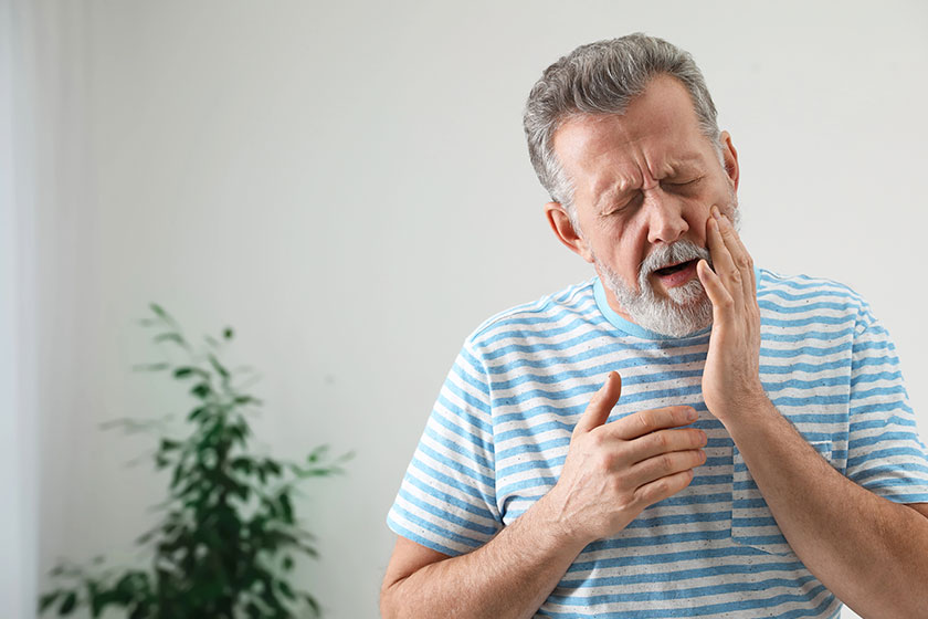 Mature man suffering from strong tooth pain Mature man suffering from strong tooth pain
