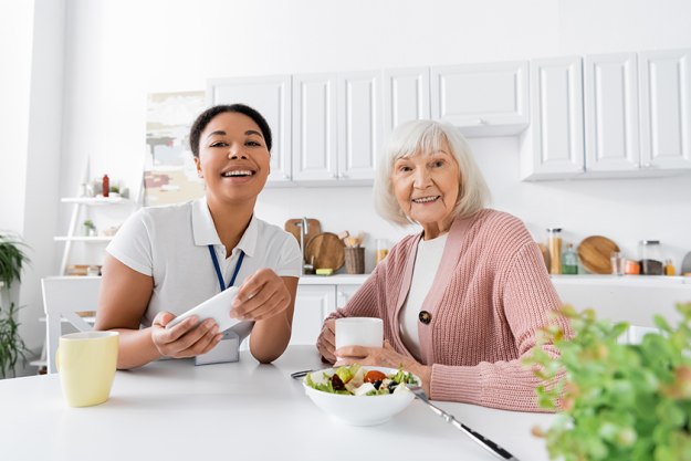 Happy multiracial social worker holding smartphone