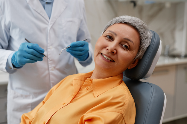 Portrait of smiling senior woman in dental clinic