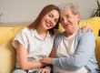 Young woman with her grandmother hugging