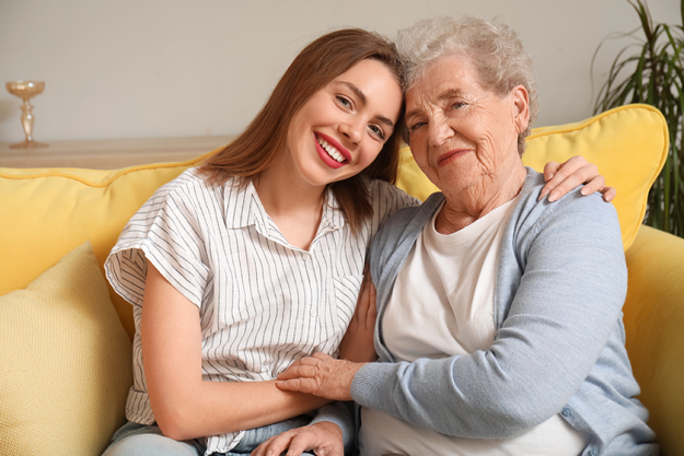 young-woman-her-grandmother-hugging-home Young woman with her grandmother hugging