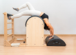 Young Asian woman working on pilates ladder barrel