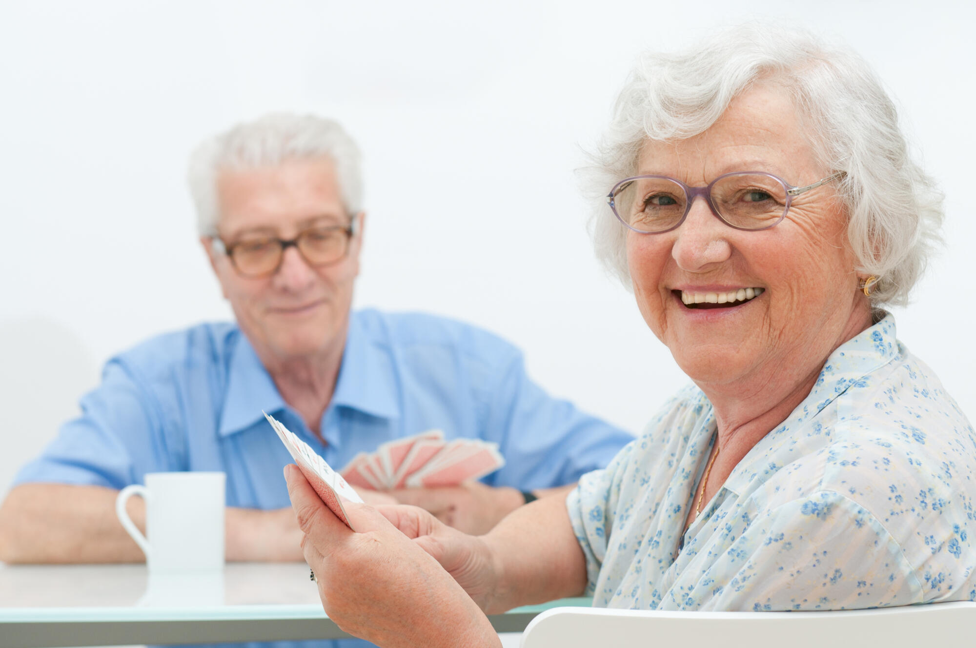 Happy,Smiling,Senior,Couple,Playing,Cards,Together,At,Home