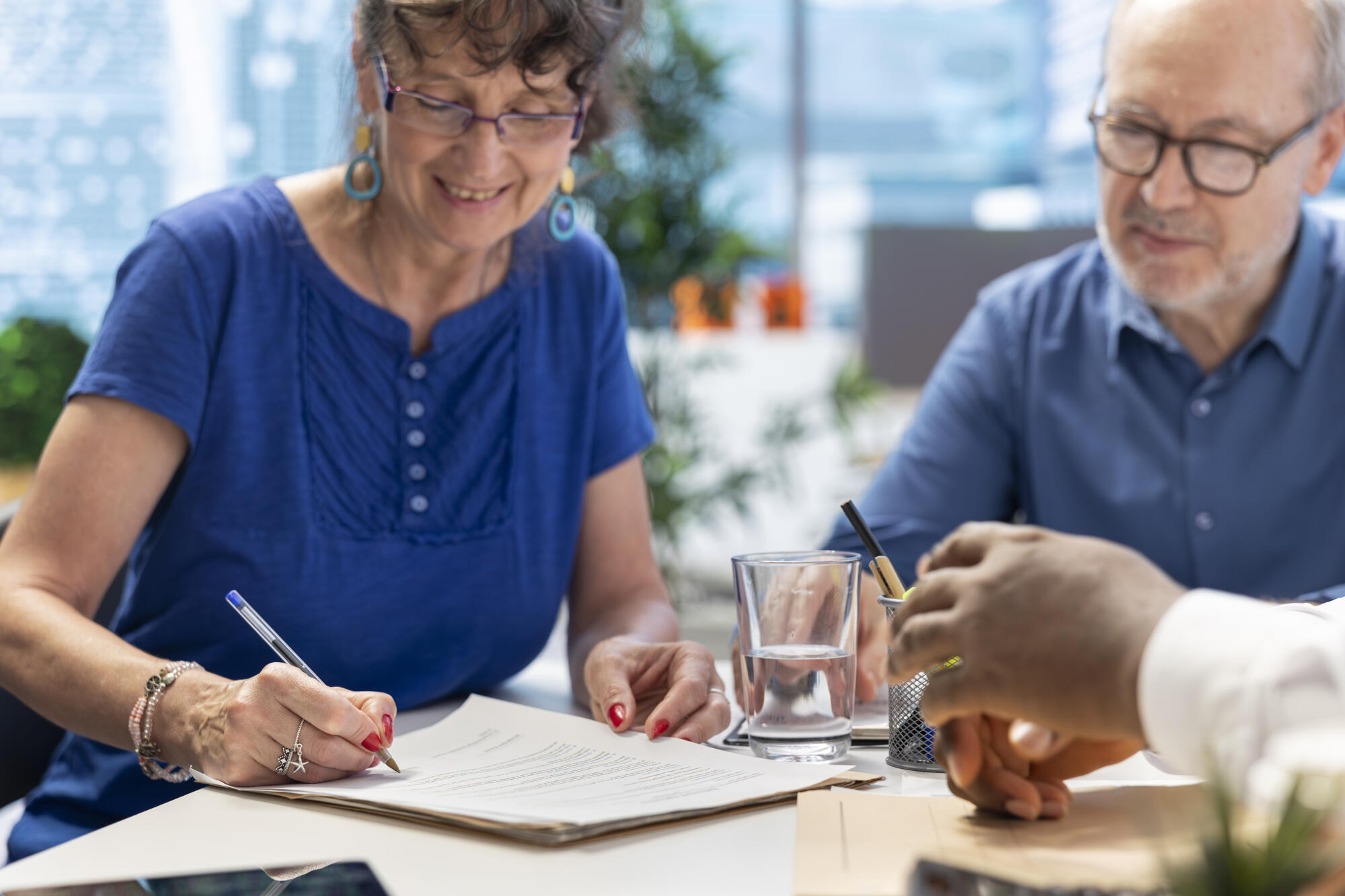 Mature woman signing retirement planning contract to secure the pension
