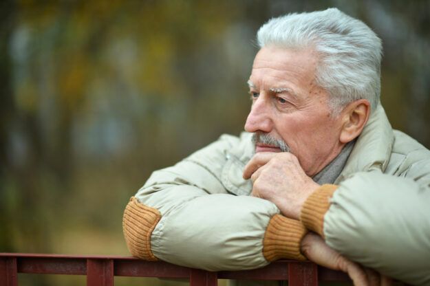 Portrait of thoughtful senior man in park